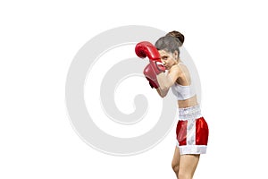 Attractive young woman in red boxing gloves and shorts stand in a boxing stance and protect her head, isolated on white.