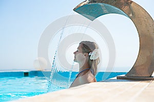 Attractive young woman refresh in pool