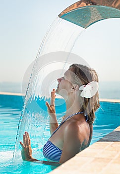 Attractive young woman refresh in pool