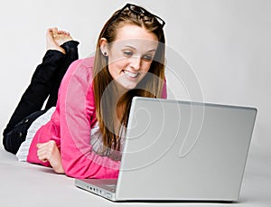 Attractive young woman relaxing with laptop