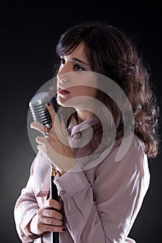 Attractive young woman with a retro microphone