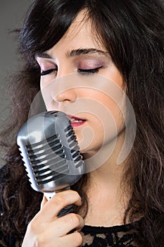 Attractive young woman with a retro microphone