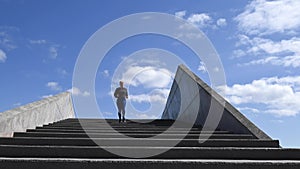 Attractive young woman, running down stairs in real time, stock footage by Brian Holm Nielsen