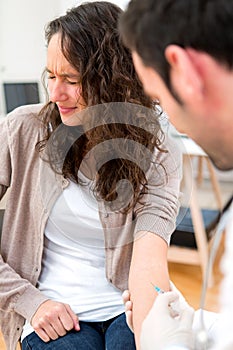 Attractive young woman scared by injection