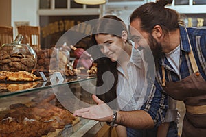 Attractive young woman shopping at bakery store