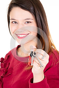 Attractive young woman showing a home keys