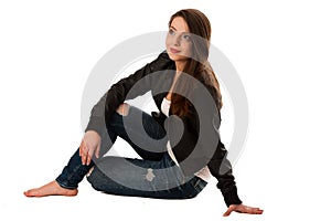 Attractive young woman sitting isolated over white background