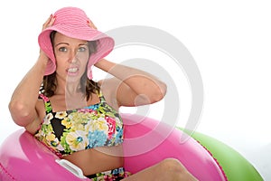 Attractive Young Woman Sitting in Rubber Ring Wearing a Swimsuit