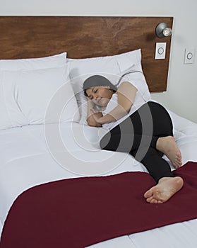 Attractive young woman sleeping well in bed.