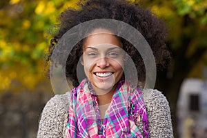 Attractive young woman smiling in autumn outdoors