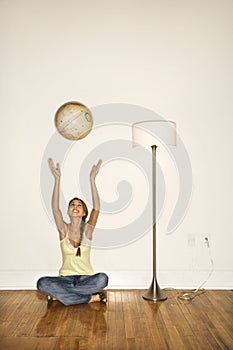 Attractive Young Woman Smiling and Sitting Tossing