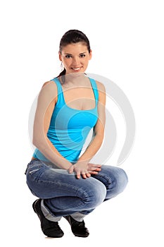 Attractive young woman in squatting position
