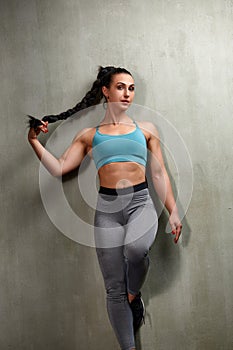 Attractive Young Woman Standing Strong In The Gym And Flexing Muscles - Beautiful Athletic Fitness Model Posing After