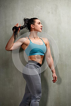 Attractive Young Woman Standing Strong In The Gym And Flexing Muscles - Beautiful Athletic Fitness Model Posing After