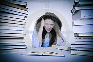 Attractive young woman student undre stress while studiing for e