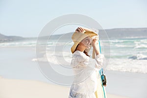 Attractive young woman with surfboard on the beach