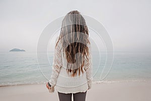 Attractive young woman in sweater watch the horizon line