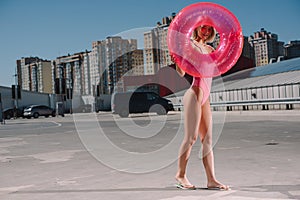 attractive young woman in swimsuit with inflatable ring