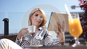 Attractive young woman with tablet in cafe