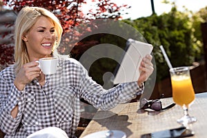 Attractive young woman with tablet in cafe