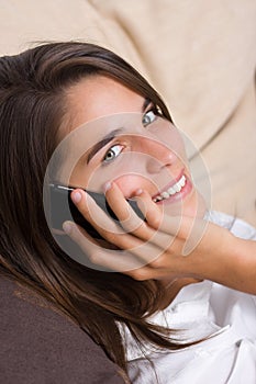 An attractive young woman talking on the phone