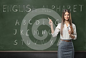 Attractive young woman teacher in a classroom