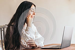 Attractive young woman using her laptop in a desk