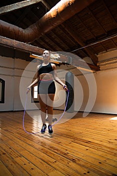 Attractive young woman using jump rope