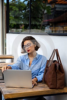 attractive young woman using laptop outside