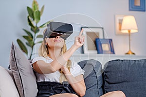 Attractive young woman in VR headset gesturing and smiling