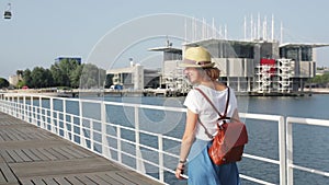 Attractive young woman walking in Lisbon near Tajus river at Park of the Nations