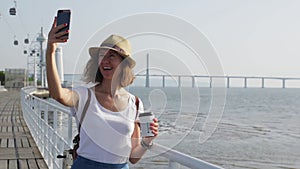 Attractive young woman walking in Lisbon near Tajus river at Park of the Nations