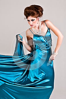 Attractive Young Woman Wearing a Blue Satin Dress