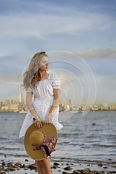 Attractive young woman wearing romantic white dress