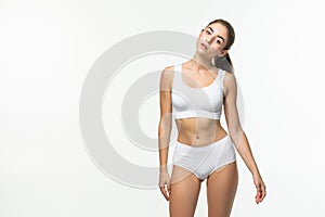 Attractive young woman in white underwear isolated on white background