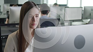 Attractive Young Woman Working on Decktop Computer While Working in Big Open Space Office. Portrait of Positive Business