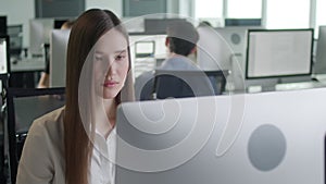 Attractive Young Woman Working on Decktop Computer While Working in Big Open Space Office. Portrait of Positive Business