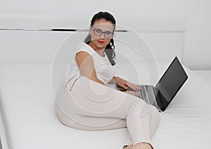 Attractive young woman working on her laptop at home