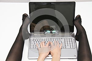 Attractive young woman working on her laptop at home