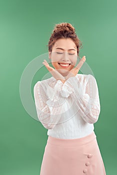 Attrative young Asian woman standing islated over green background