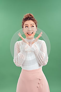 Attrative young Asian woman standing islated over green background