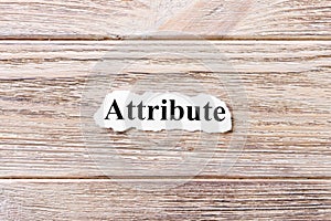 Attribute of the word on paper. concept. Words of attribute on a wooden background