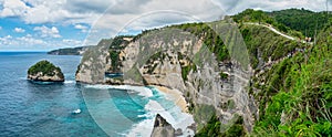 Atuh Beach is a Rustic, isolated cove beneath a sheer cliff face, with a sandy beach offshore rock formations