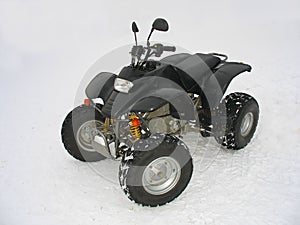 ATV Black All Terrain Vehicle on white snow