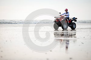 ATV driver on the beach