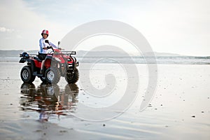 ATV driver on the beach