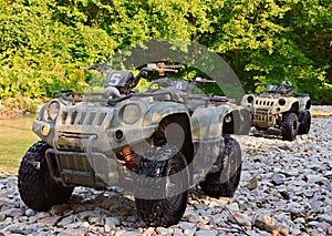 ATV parked on the shore of a mountain river