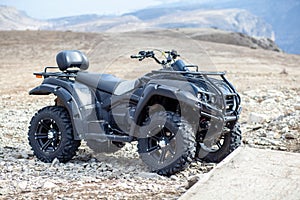 ATV Quad Bike in front of mountains landscape.