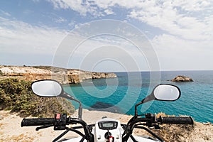 ATV quad bike parked on the shore of Aegean sea on Milos island, Greece