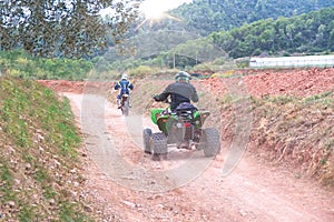 ATV quad motorcycle on a rural forest track next to a sportive motorcycle in a adventure sport activity. Empty copy space